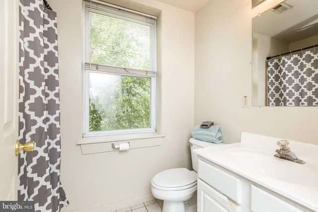 a bathroom with a shower curtain and a sink