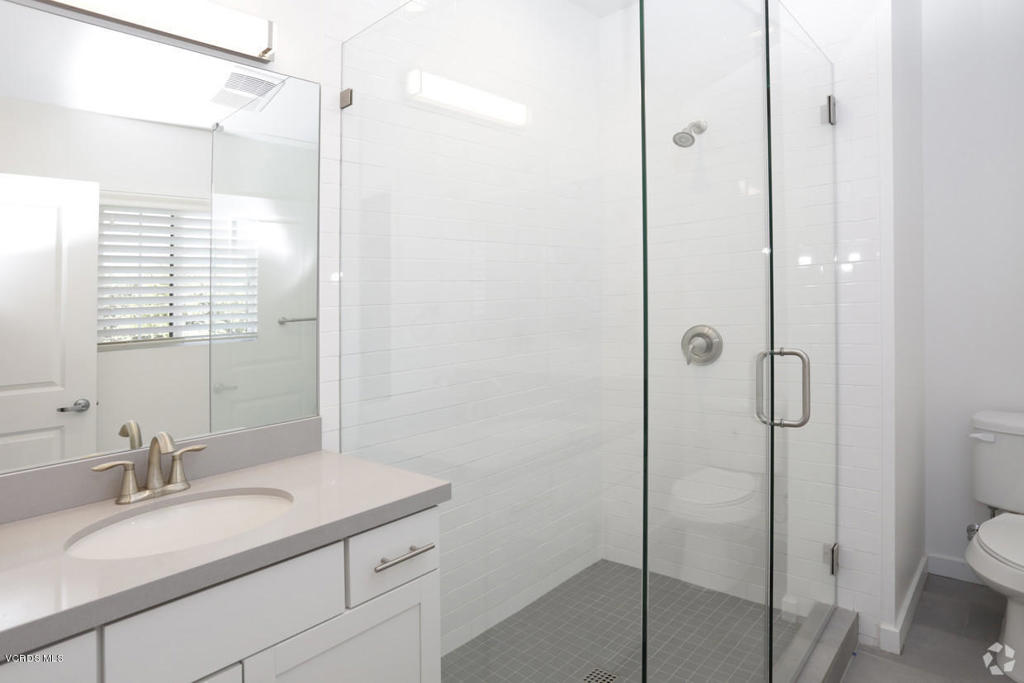 5250 Chesebro Road, Unit 13 Agoura Hills, CA 91301 - Photo 16 of 29 a bathroom with a granite countertop sink toilet and shower