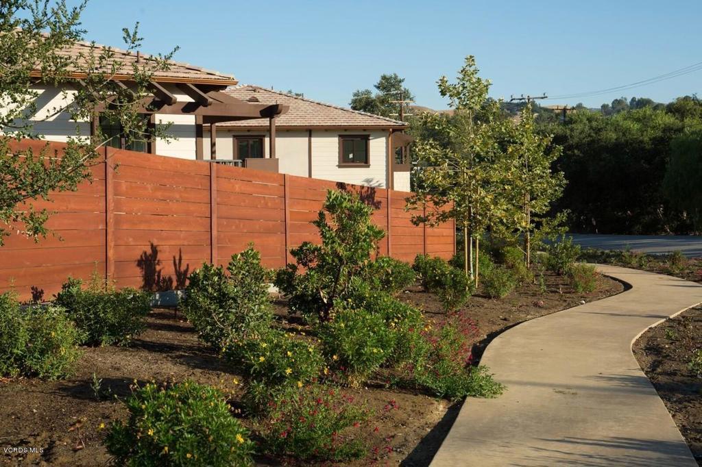 5250 Chesebro Road, Unit 13 Agoura Hills, CA 91301 - Photo 24 of 29 a front view of a house with a garden