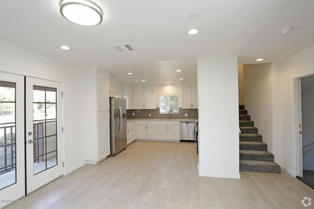 5250 Chesebro Road, Unit 13 Agoura Hills, CA 91301 - Photo 6 of 29 a view of a kitchen with refrigerator and white cabinets
