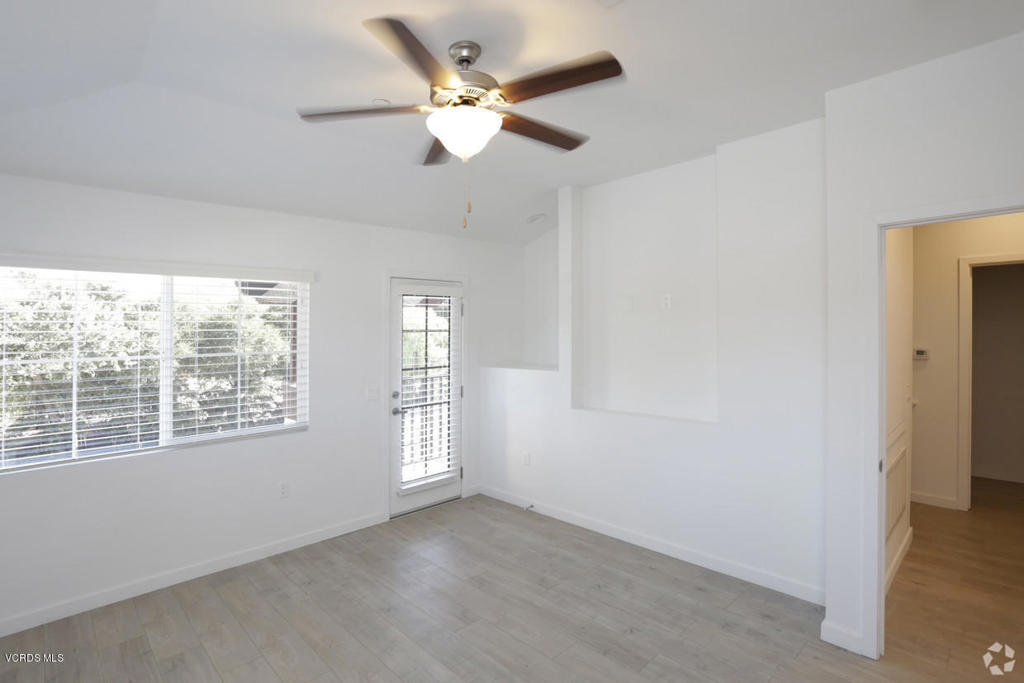 5250 Chesebro Road, Unit 13 Agoura Hills, CA 91301 - Photo 8 of 29 an empty room with windows and ceiling fan