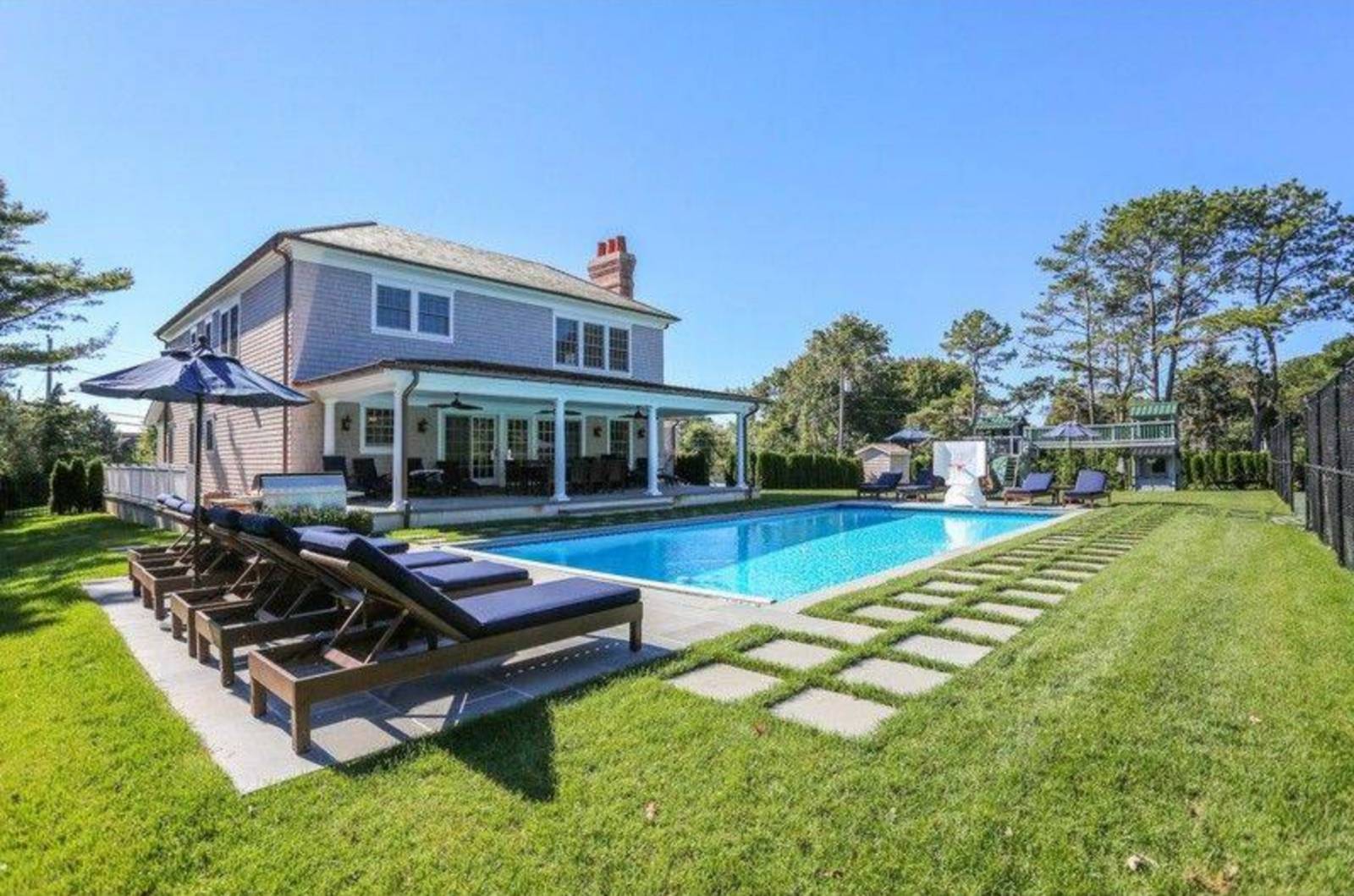 39 Middle Pond Road Southampton, NY 11968 - Photo 1 of 3 a swimming pool with outdoor seating and yard