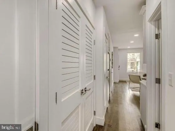 a view of a hallway with a wooden floors
