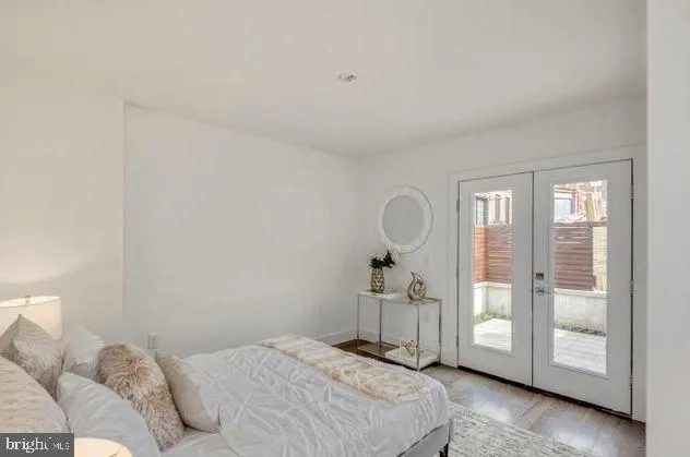 a bedroom with a bed and glass door