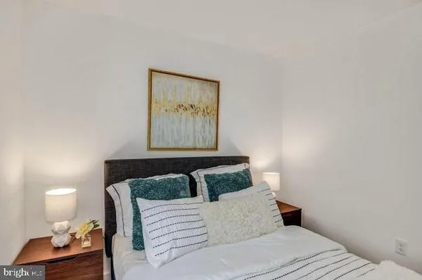 a bedroom with a bed and night stand