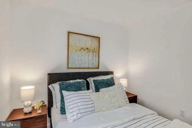 a bedroom with a bed and night stand