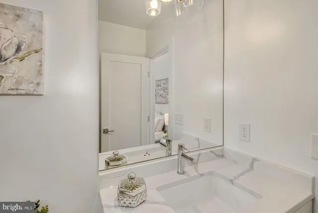a bathroom with a granite countertop sink and a bathtub