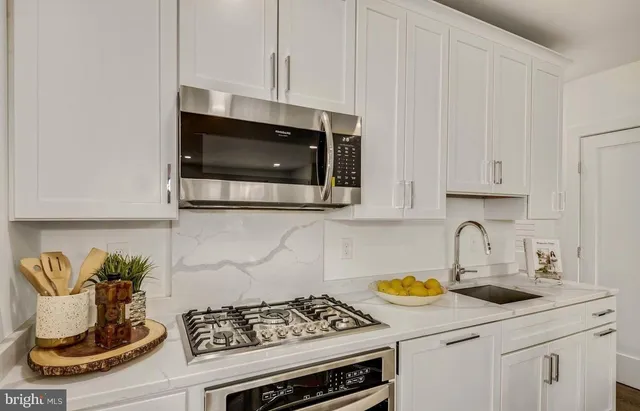 a kitchen with a stove and cabinets