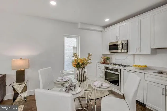 a kitchen with a sink stove and microwave