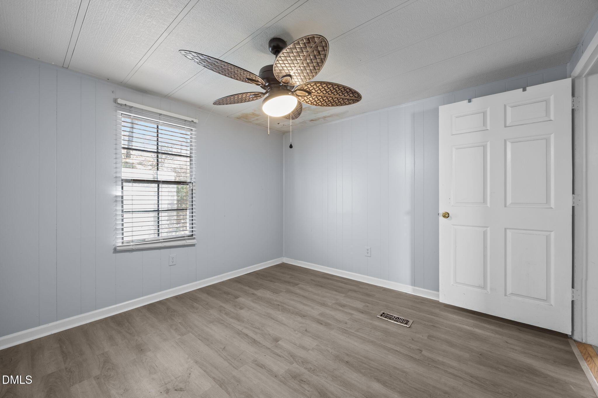 4029 Strickland Farm Road Raleigh, NC 27604 - Photo 33 of 40 a view of an empty room with wooden floor and a window