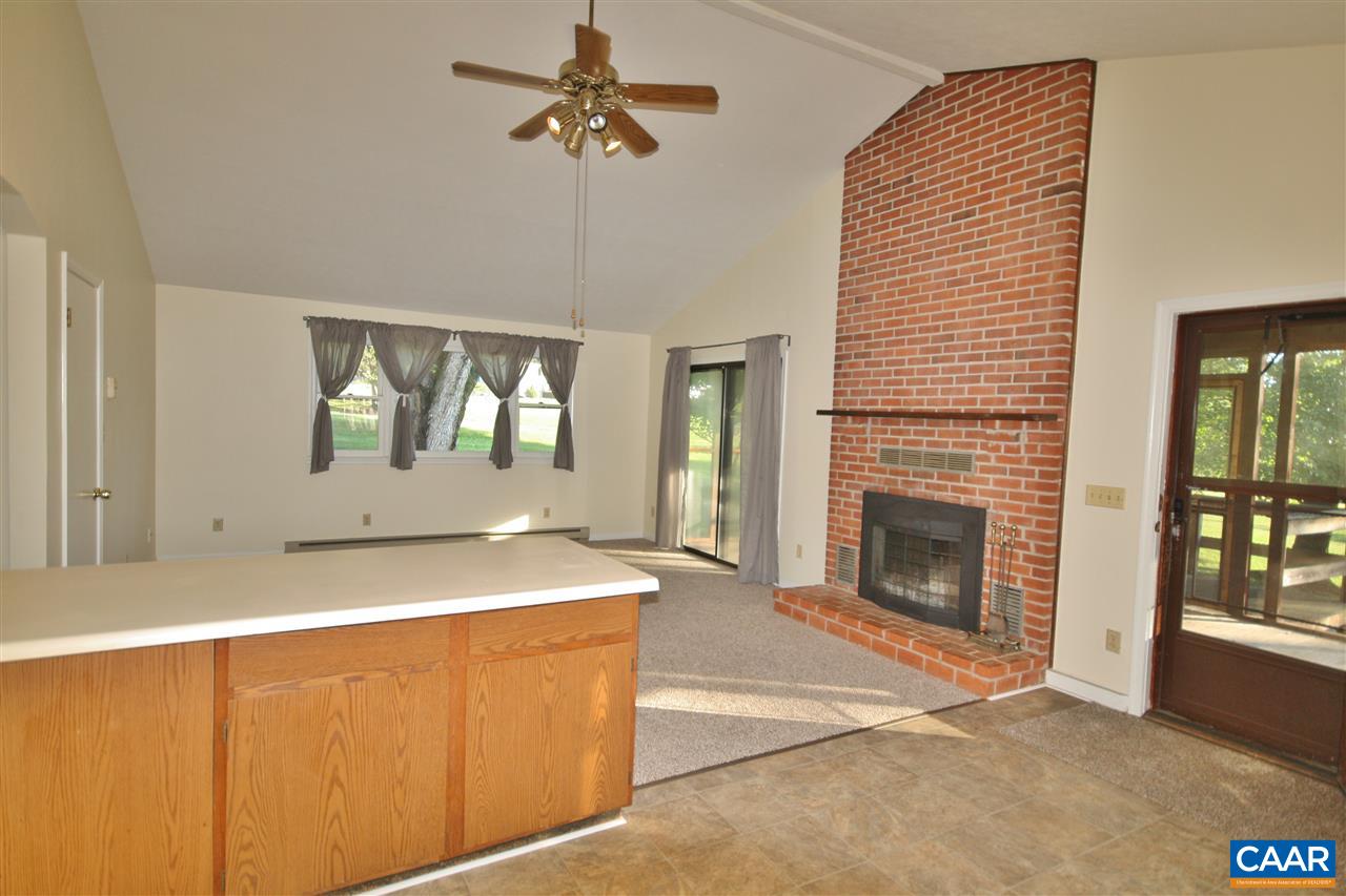 65 Gladiola Road Ruckersville, VA 22968 - Photo 4 of 19 a spacious bedroom with a bed and a fireplace
