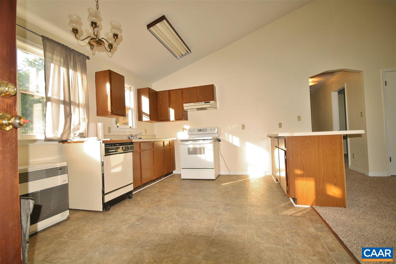 65 Gladiola Road Ruckersville, VA 22968 - Photo 6 of 19 a white kitchen with stainless steel appliances granite countertop a stove and a sink