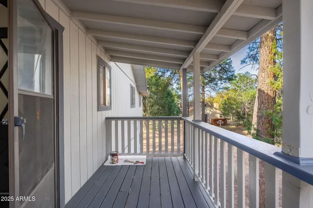 a view of a balcony with wooden floor