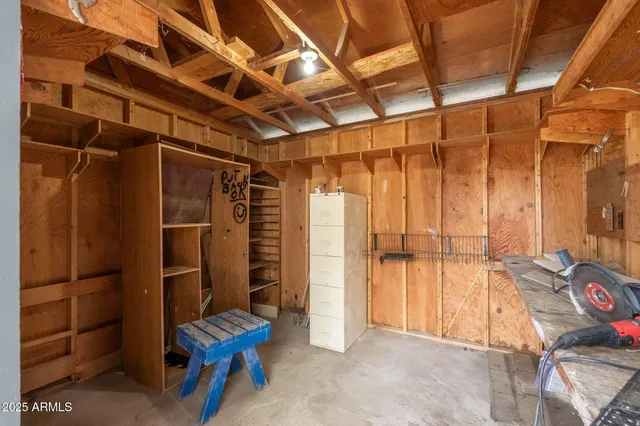 a backyard of a house with large trees and outdoor seating