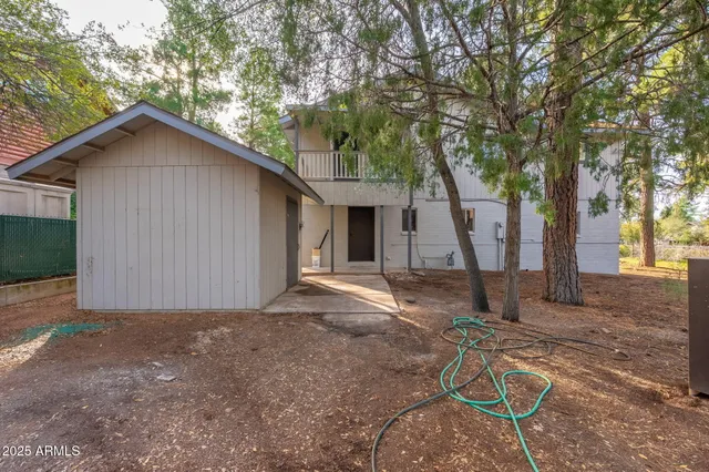 a view of a house with backyard and trees