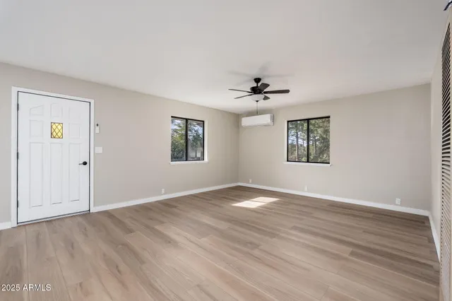 a view of a kitchen with wooden floor and a ceiling fan