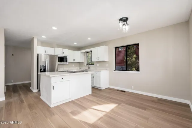 a view of kitchen with cabinets and wooden floor