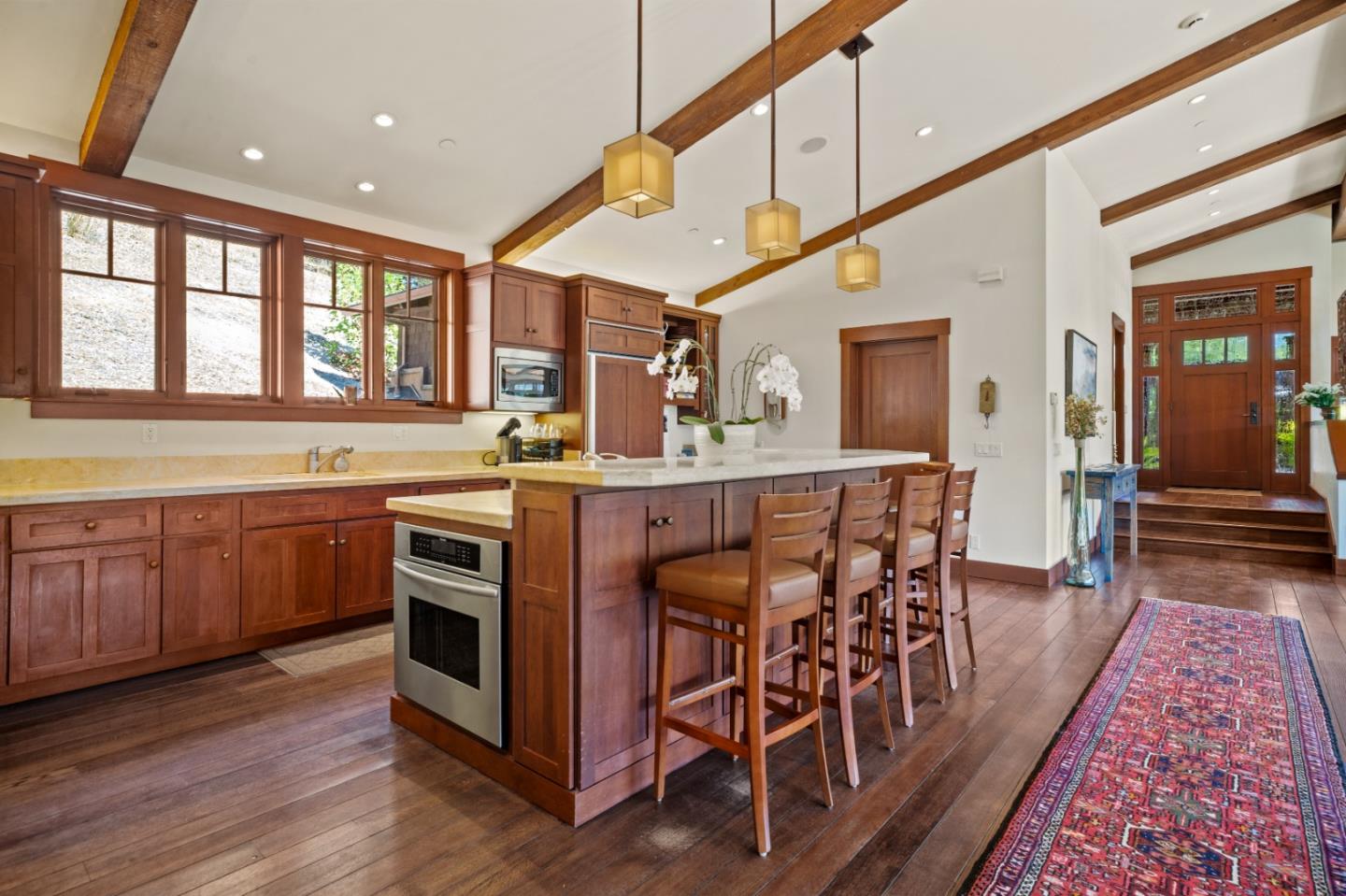 43 Rancho San Carlos Road Carmel, CA 93923 - Photo 13 of 51 a kitchen with stainless steel appliances granite countertop a stove a sink dishwasher and a dining table with wooden floor