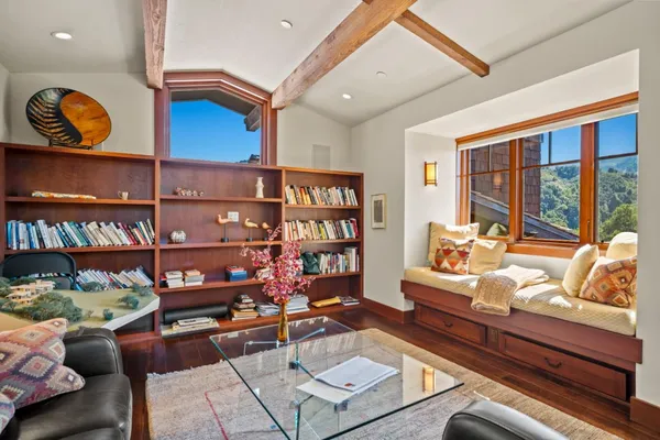 a living room with lots of furniture and a book shelf