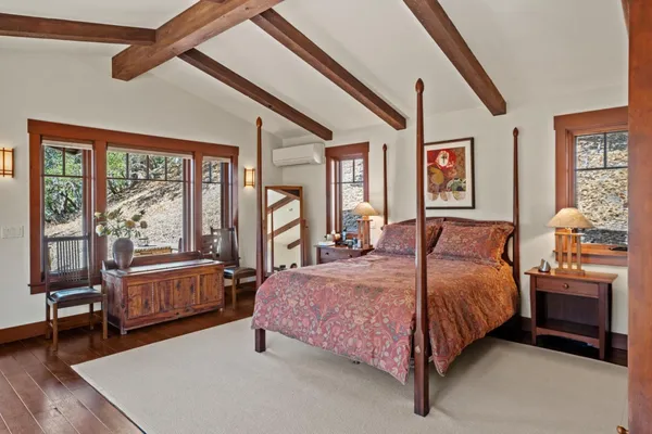 a bedroom with a bed and wooden floor
