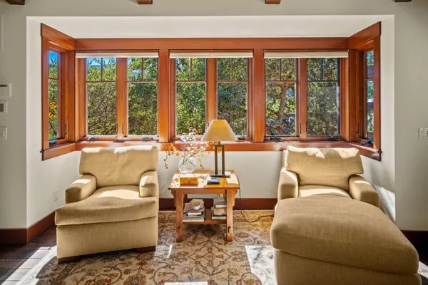 a living room with furniture and large windows