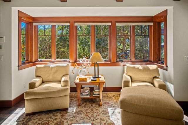 a living room with furniture and large windows