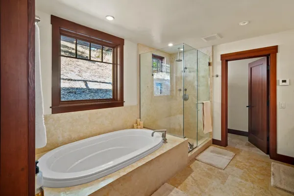 a bathroom with a tub and a shower