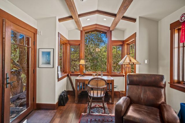 a living room with furniture a window and wooden floor