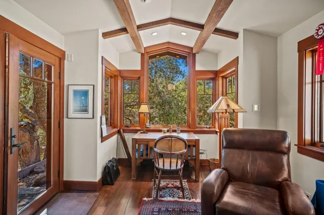 a living room with furniture a window and wooden floor
