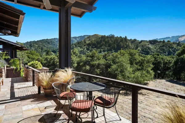 a balcony with table and chairs