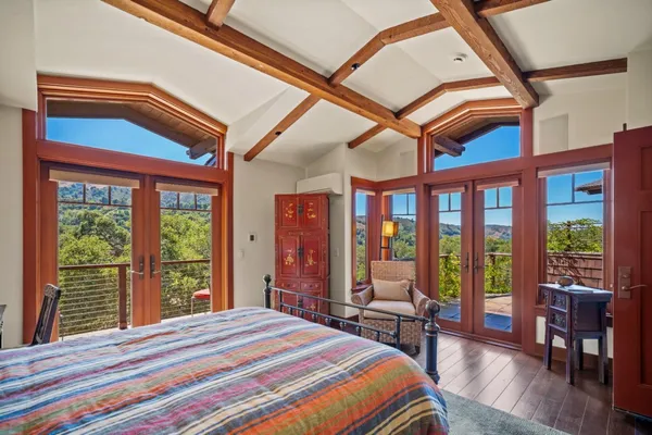 a bedroom with a bed and a large window