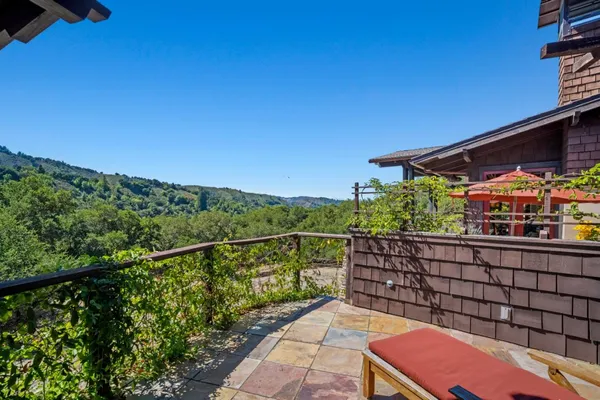 a view of a balcony with two chairs and a table