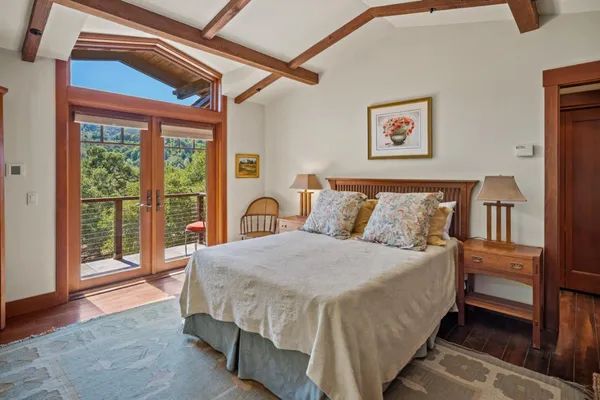 a bedroom with a bed and a large window