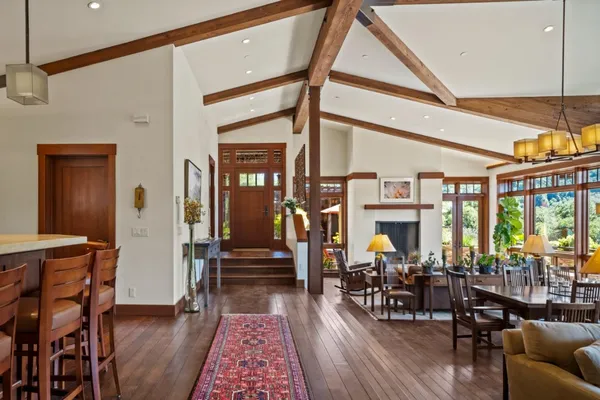 a living room with furniture a rug and a large window