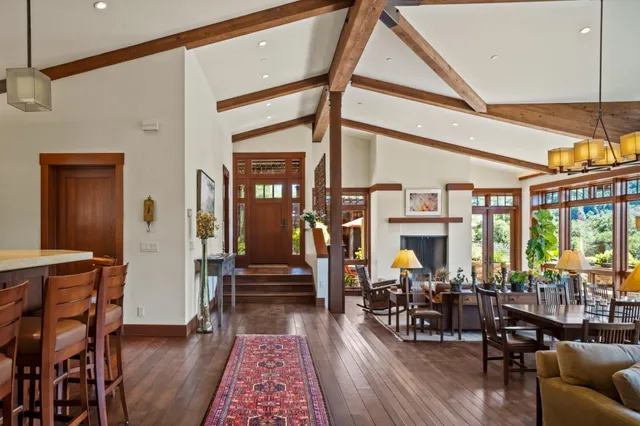 a living room with furniture a rug and a large window