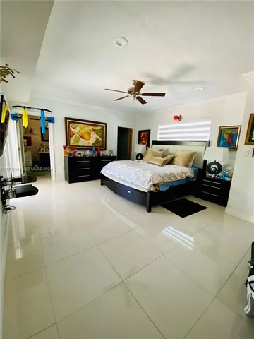 a bedroom with a bed and ceiling fan
