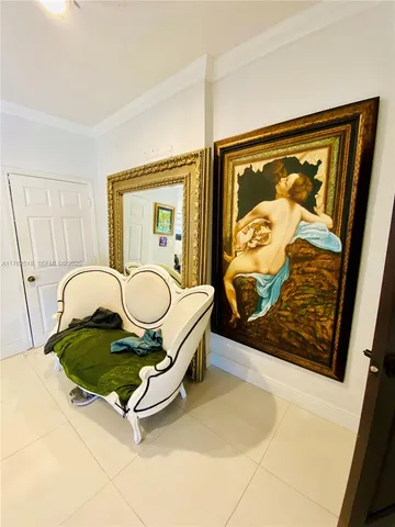 a living room with patio furniture and a rug