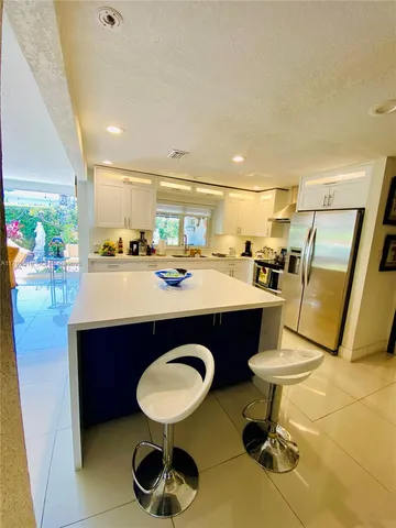 a kitchen with stainless steel appliances granite countertop a stove and a sink