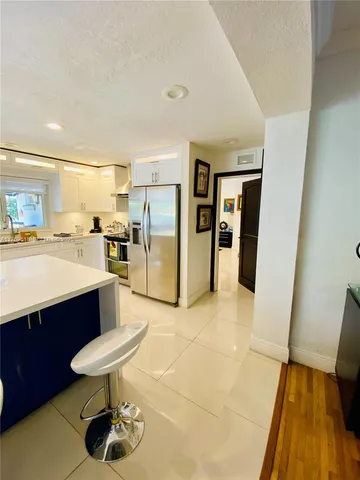 a kitchen with stainless steel appliances granite countertop a sink counter space cabinets and a stove