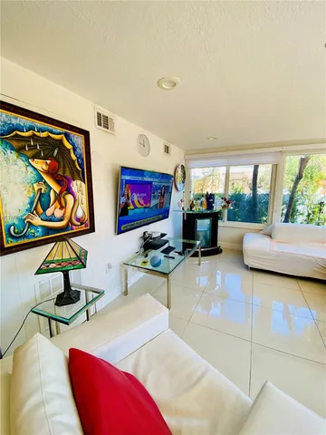 a view of a house with a big yard and large trees