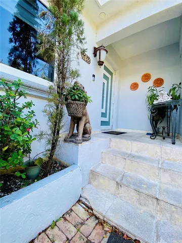 a table with a vase and flowers on it
