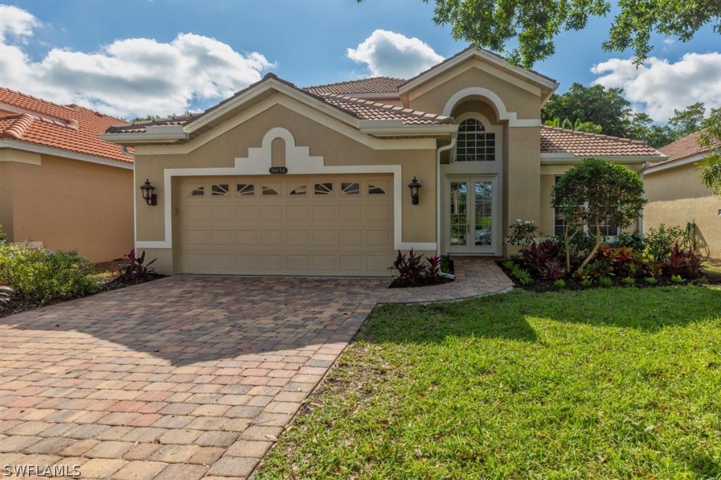 8856 Ventura Way Naples, FL 34109 - Photo 1 of 34 a front view of a house with garden