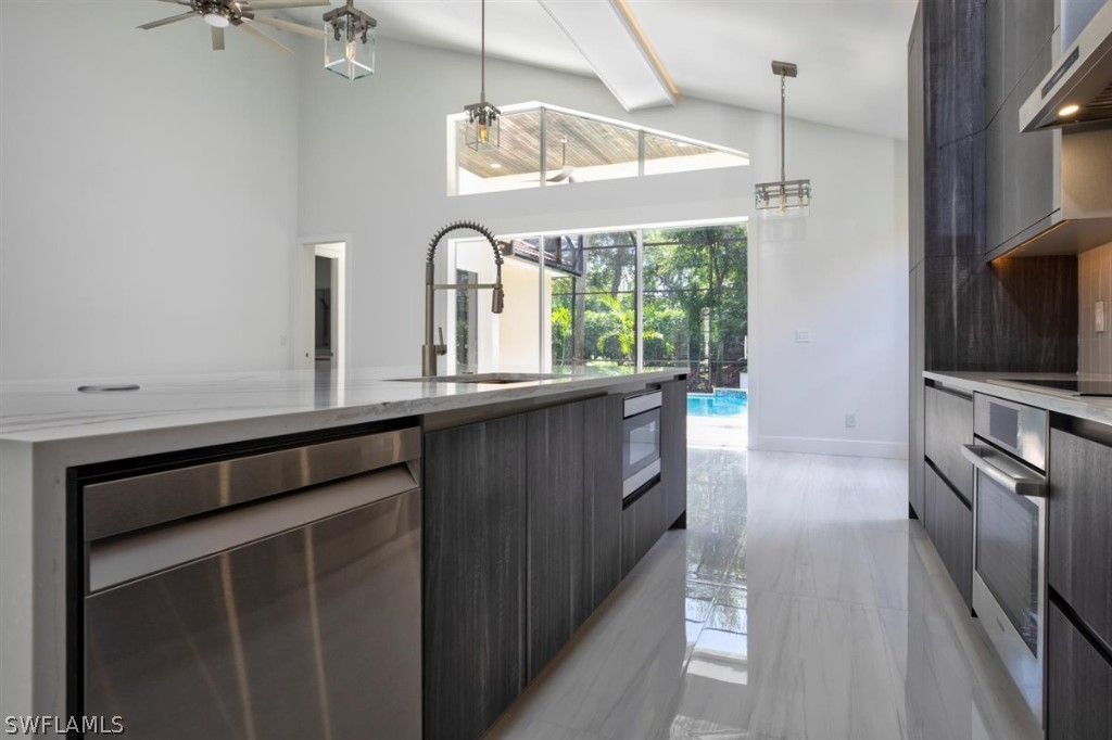 8856 Ventura Way Naples, FL 34109 - Photo 11 of 34 a kitchen with granite countertop a stove a sink and a refrigerator