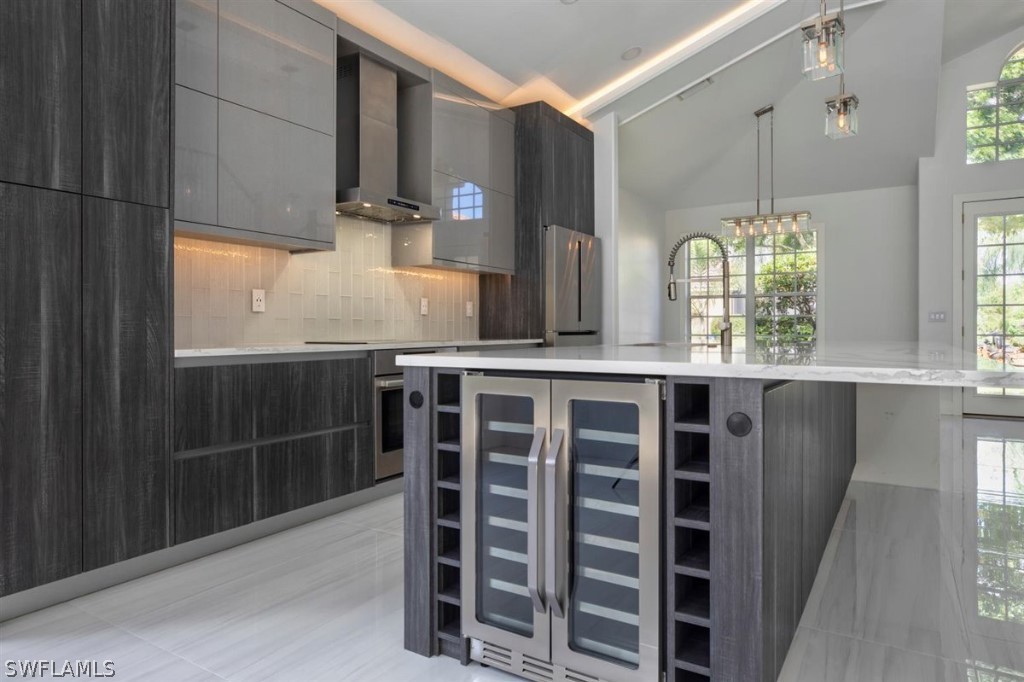 8856 Ventura Way Naples, FL 34109 - Photo 13 of 34 a kitchen with windows and cabinets