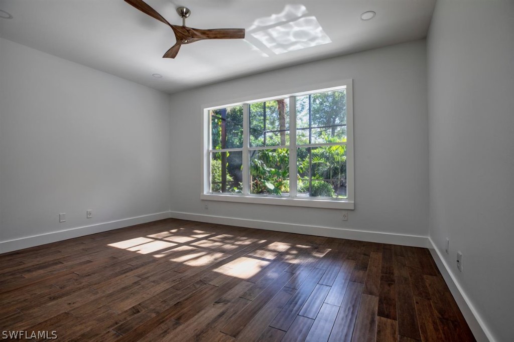 8856 Ventura Way Naples, FL 34109 - Photo 17 of 34 a view of an empty room with wooden floor and a window