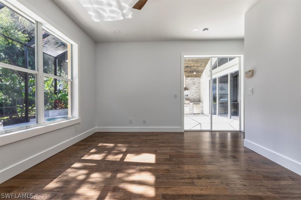 8856 Ventura Way Naples, FL 34109 - Photo 18 of 34 a view of an empty room with wooden floor and a window