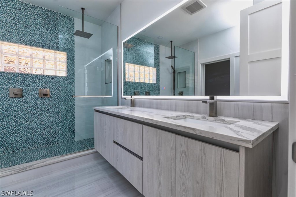8856 Ventura Way Naples, FL 34109 - Photo 19 of 34 a bathroom with a granite countertop sink mirror and double