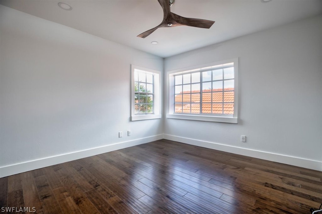 8856 Ventura Way Naples, FL 34109 - Photo 25 of 34 a view of an empty room with wooden floor and a window