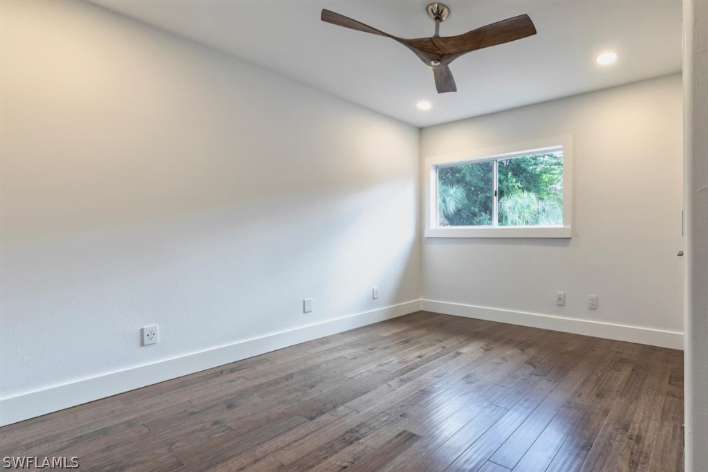 8856 Ventura Way Naples, FL 34109 - Photo 27 of 34 an empty room with wooden floor and windows