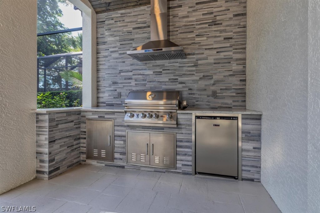 8856 Ventura Way Naples, FL 34109 - Photo 29 of 34 a kitchen with a stove and a cabinets